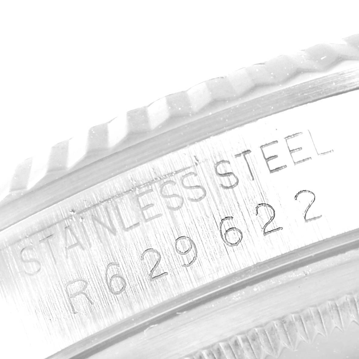 The image shows a close-up of the stainless steel bezel and serial number of a Rolex Datejust 16234 Men's Stainless Steel Silver Dial 16234 Men's Stainless Steel Silver Dial watch.