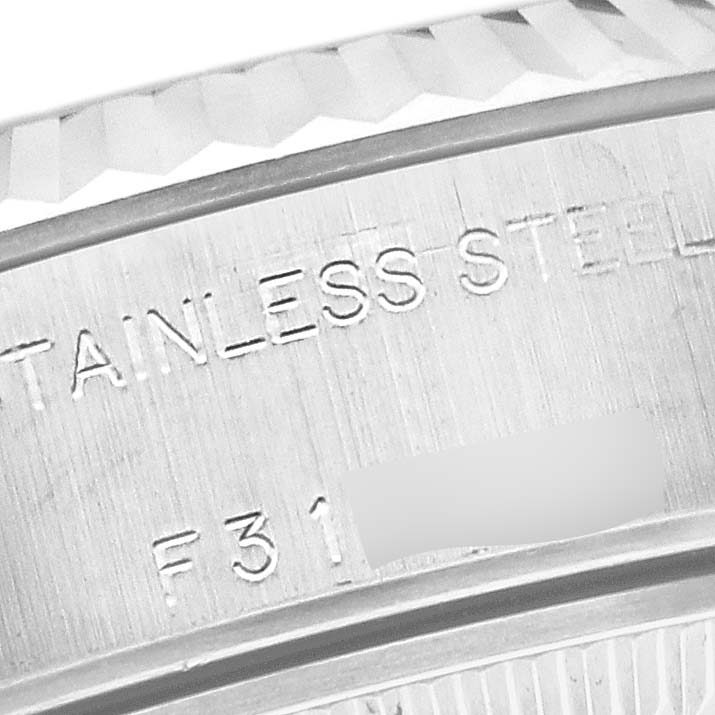 The image shows an angled close-up of the stainless steel caseback and fluted bezel of a Rolex Datejust 79174 Women's Stainless Steel Silver Dial 79174 Women's Stainless Steel Silver Dial watch.