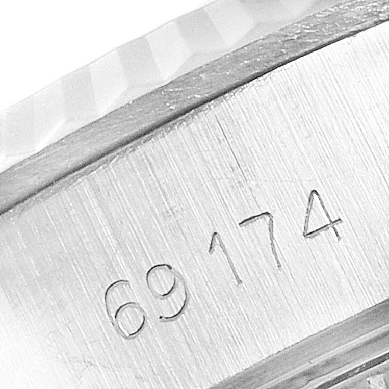 The image shows a close-up of the engraved reference number and fluted bezel on a Rolex Datejust 69174 Women's Steel and Gold (two tone) Silver Dial 69174 Women's Steel and Gold (two tone) Silver Dial watch.