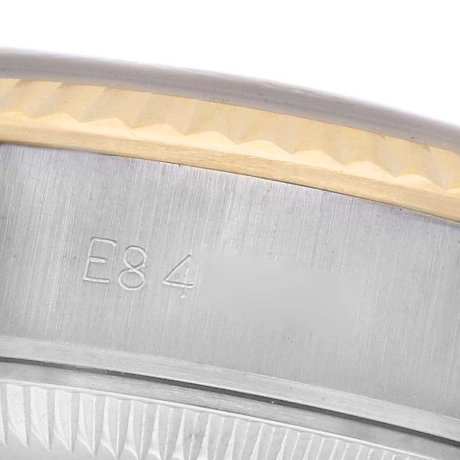 The image shows a close-up of the side of a Rolex Datejust 69173 Women's Steel and Gold (two tone) Champagne Dial 69173 Women's Steel and Gold (two tone) Champagne Dial, highlighting the bezel and case engravings.