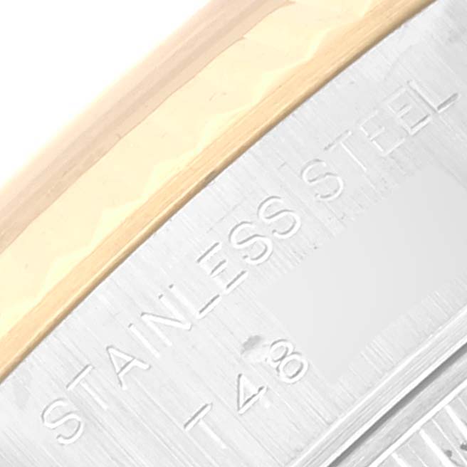 This is a close-up angle of the bezel and edge of the casing of the Rolex Datejust 69173 Women's Steel and Gold (two tone) Champagne Dial 69173 Women's Steel and Gold (two tone) Champagne Dial model, showing "STAINLESS STEEL" engraving.