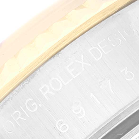 The image shows a close-up of the bezel and case side with engraved text on a Rolex Datejust 69173 Women's Steel and Gold (two tone) Champagne Dial 69173 Women's Steel and Gold (two tone) Champagne Dial watch.