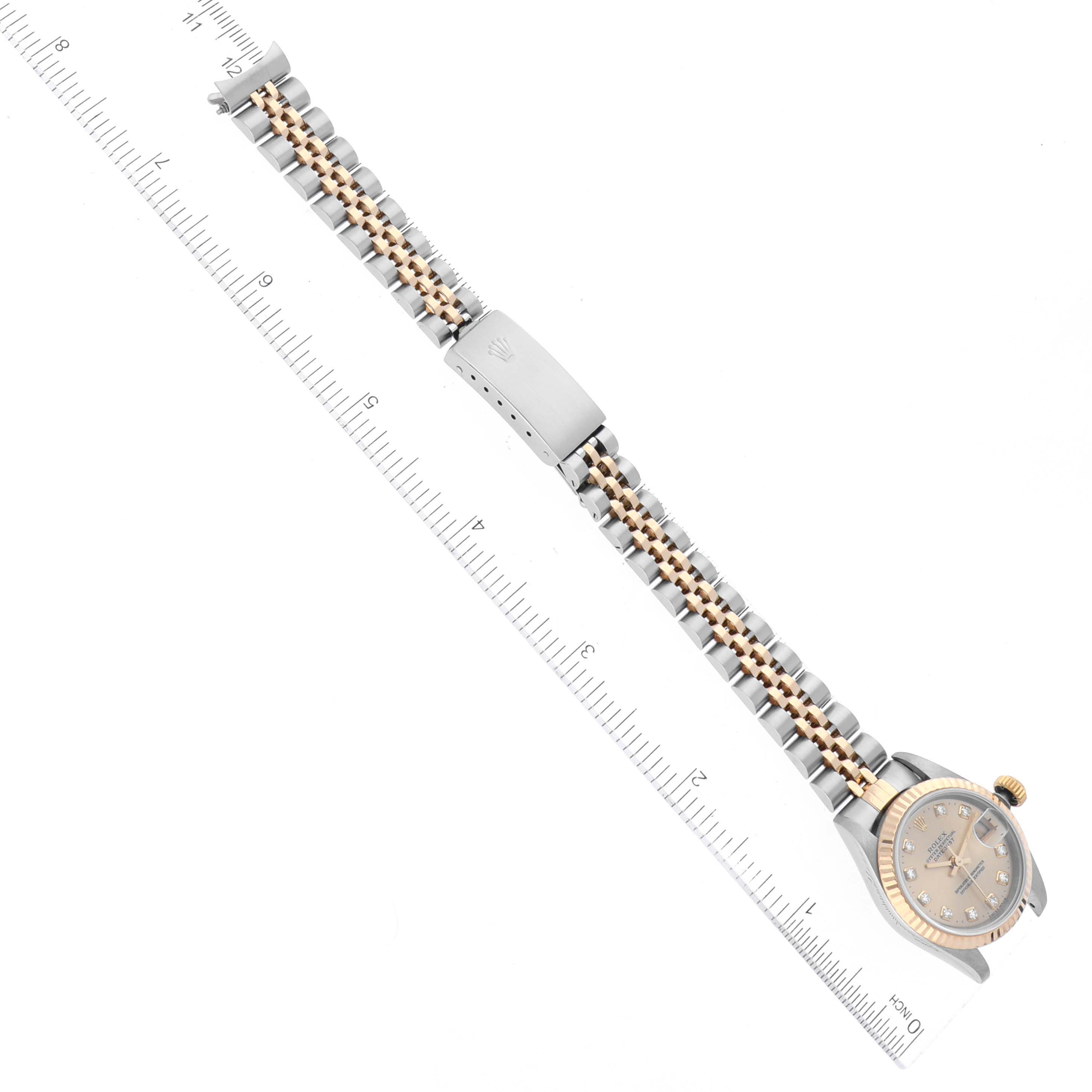 The image shows a Rolex Datejust 69173 Women's Steel and Gold (two tone) Champagne Dial 69173 Women's Steel and Gold (two tone) Champagne Dial watch laid flat, displaying its face, bezel, and two-tone jubilee bracelet alongside a ruler.