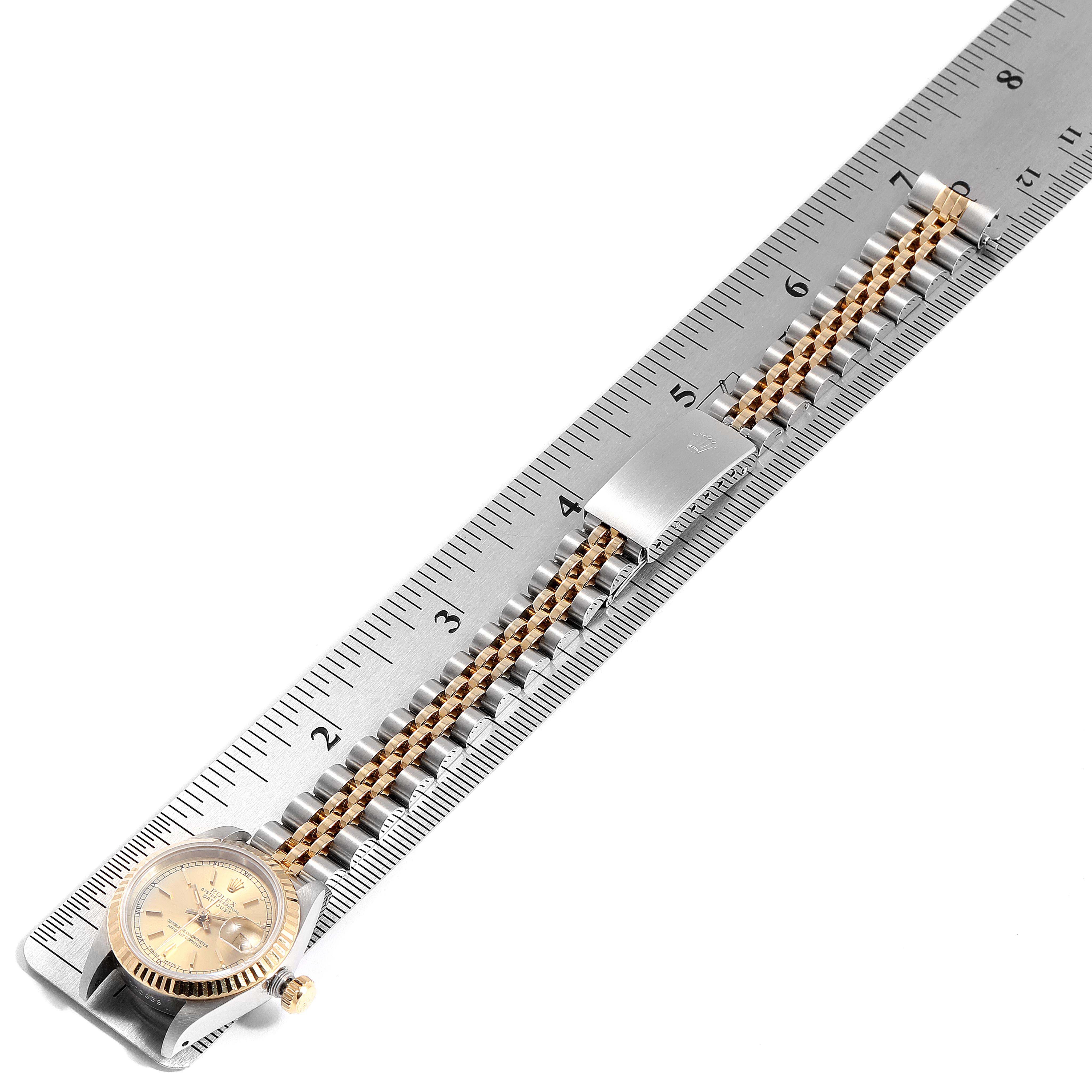 The Rolex Datejust 69173 Women
s Steel and Gold (two tone) Champagne Dial 69173 Women
s Steel and Gold (two tone) Champagne Dial watch is shown from the side, showcasing the band with a ruler measuring its length.