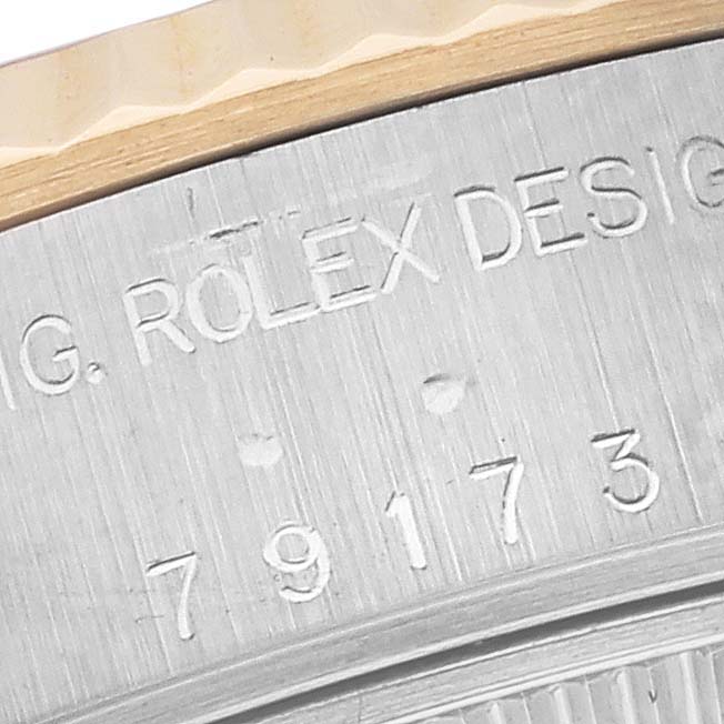 The image shows a close-up angle of the case back of the Rolex Datejust 79173 Women's Steel and Gold (two tone) Red Dial 79173 Women's Steel and Gold (two tone) Red Dial, revealing engraving details.
