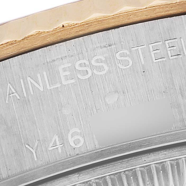 The image shows a close-up of the stainless steel and gold bezel and part of the case back of a Rolex Datejust 79173 Women's Steel and Gold (two tone) Red Dial 79173 Women's Steel and Gold (two tone) Red Dial watch.