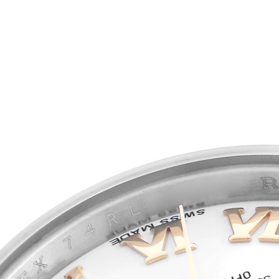 The image shows a close-up of the edge of a Rolex Datejust 179173 Women's Steel and Gold (two tone) White Dial 179173 Women's Steel and Gold (two tone) White Dial watch dial with the bezel and part of the Roman numeral indices.