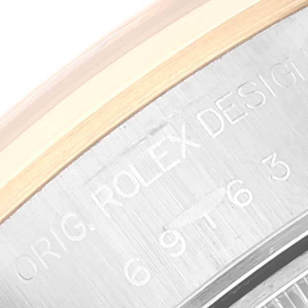 The image shows the engravings on the side of the Rolex Datejust 69163 Women's Steel and Gold (two tone) Grey Dial 69163 Women's Steel and Gold (two tone) Grey Dial watch case, featuring part of the bezel and serial number.