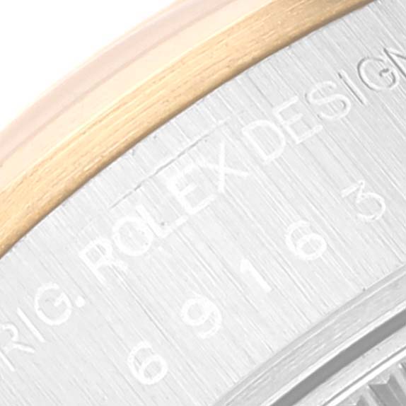 This close-up image shows the side engraving and part of the bezel of the Rolex Datejust 69163 Women's Steel and Gold (two tone) Grey Dial 69163 Women's Steel and Gold (two tone) Grey Dial watch.