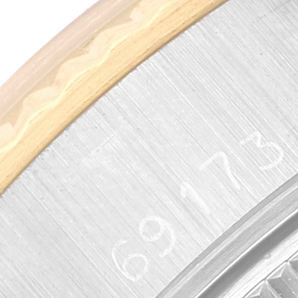 The image shows a close-up of the serial number engraving and part of the bezel of a Rolex Datejust 69173 Women's Steel and Gold (two tone) White Dial 69173 Women's Steel and Gold (two tone) White Dial watch.