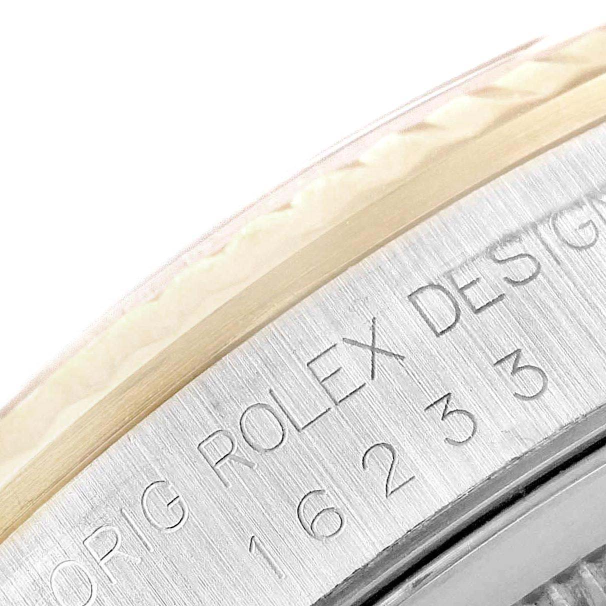 This close-up shows the engraved case side of a Rolex Datejust 16233 Men
s Steel and Gold (two tone) White Dial 16233 Men
s Steel and Gold (two tone) White Dial watch, highlighting the model number "16233" and "ORIG ROLEX DESIGN" text.