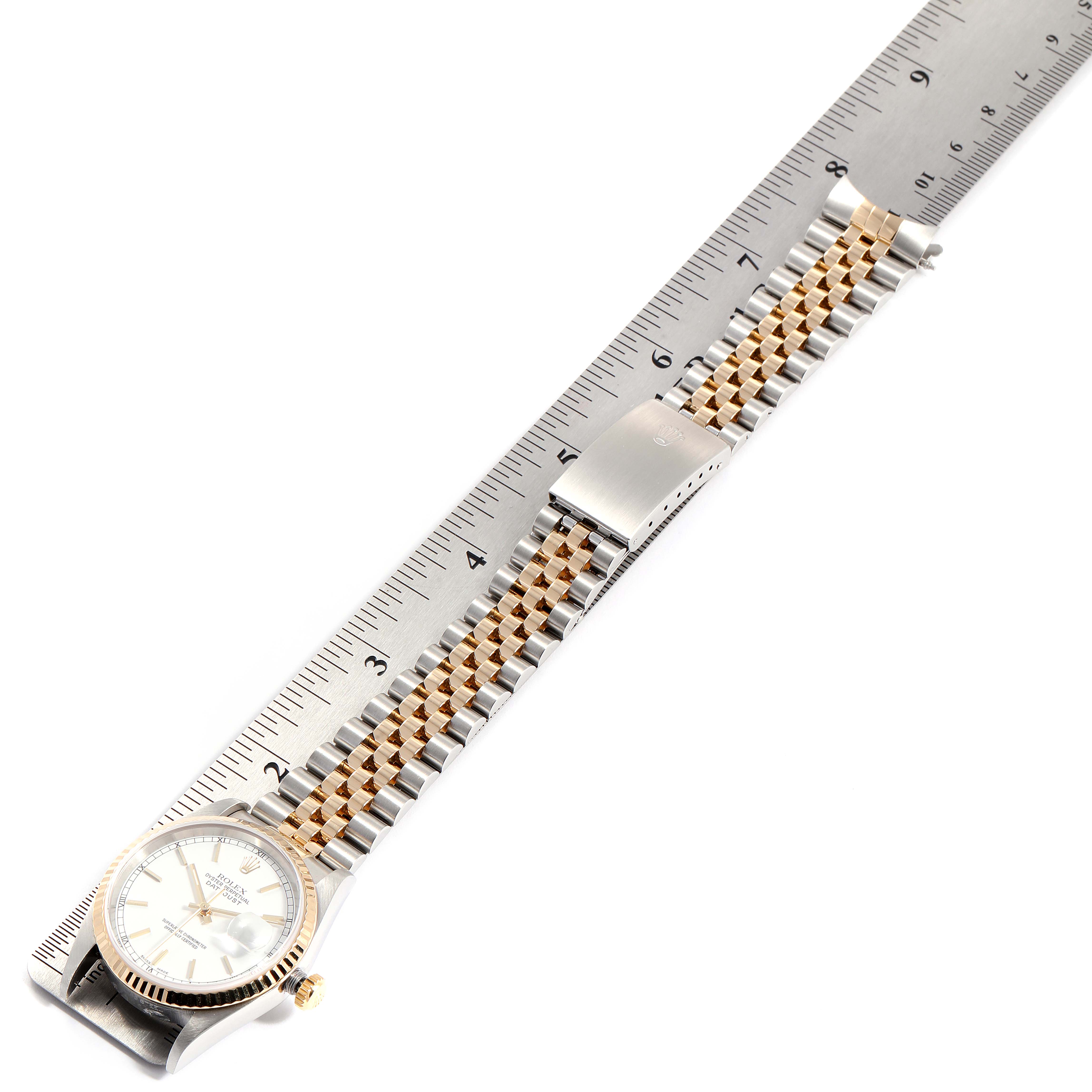 This image shows the Rolex Datejust 16233 Men
s Steel and Gold (two tone) White Dial 16233 Men
s Steel and Gold (two tone) White Dial watch laid flat next to a ruler, displaying the dial, bracelet, and clasp.