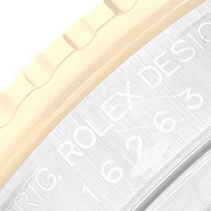 The image shows a close-up of the engraved case edge of a Rolex Turn-o-Graph 16263 Men
s Steel and Gold (two tone) White Dial 16263 Men
s Steel and Gold (two tone) White Dial watch.