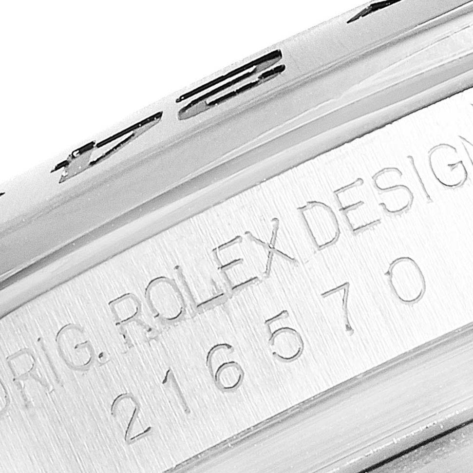 This image shows a close-up of the side of a Rolex Explorer 216570 Men
s Stainless Steel White Dial 216570 Men
s Stainless Steel White Dial watch with the model and serial numbers engraved.