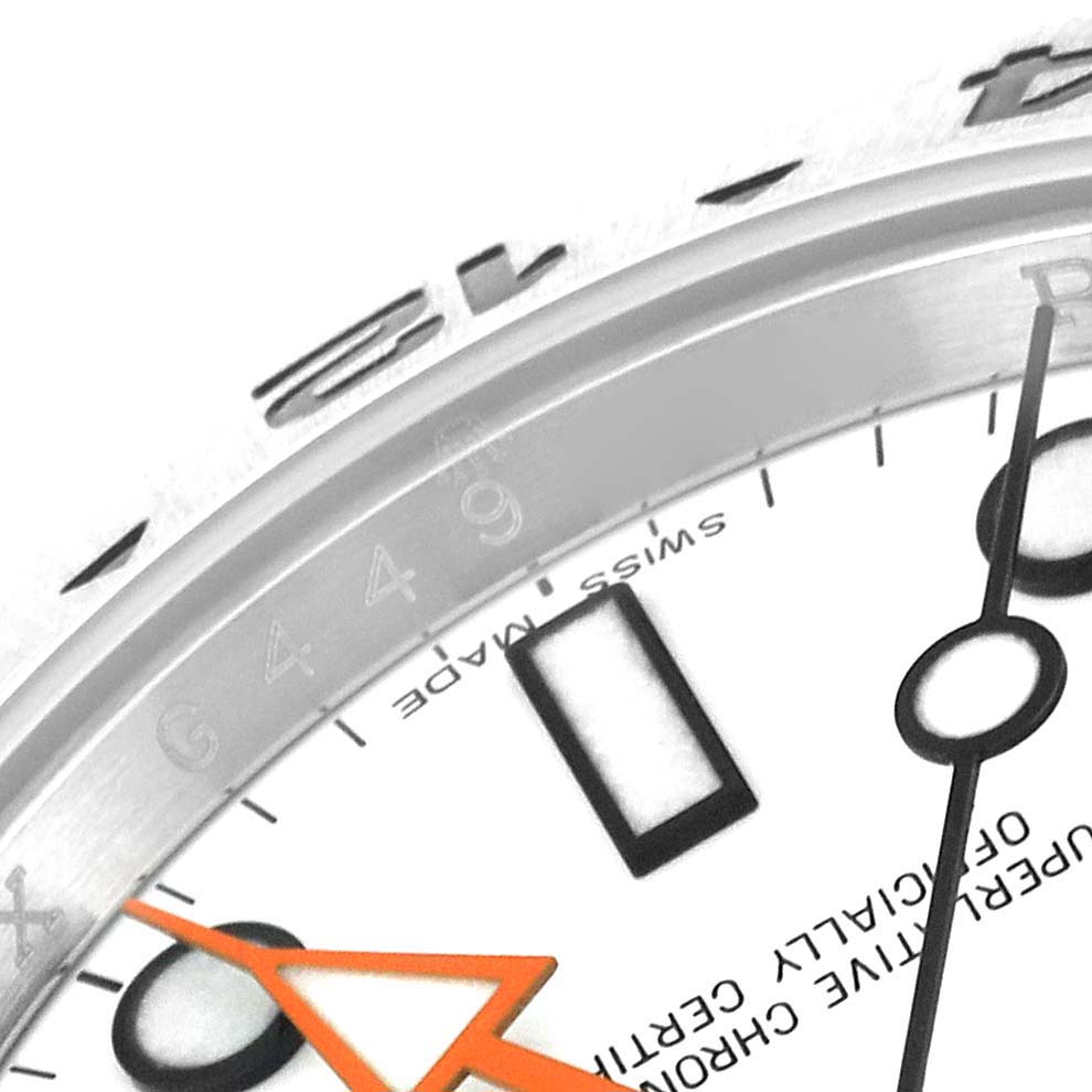 Close-up of the Rolex Explorer 216570 Men
s Stainless Steel White Dial 216570 Men
s Stainless Steel White Dial
s dial, showing the hands, markers, and partial bezel with engraved text.