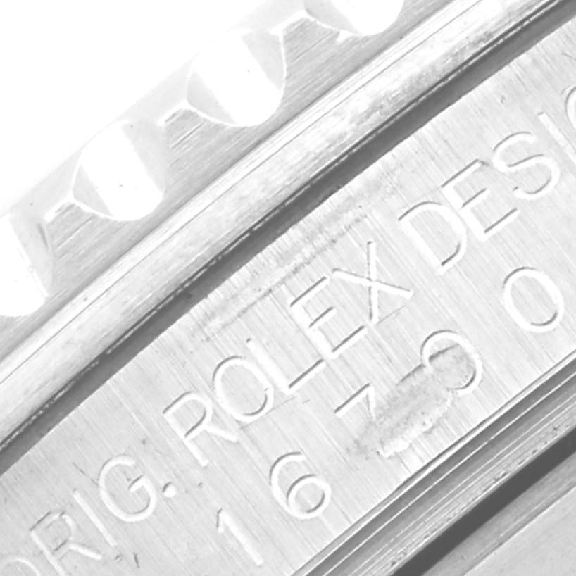 Close-up of the side of a Rolex GMT-Master 16700 Men's Stainless Steel Black Dial 16700 Men's Stainless Steel Black Dial, showing the model number and part of the bezel.
