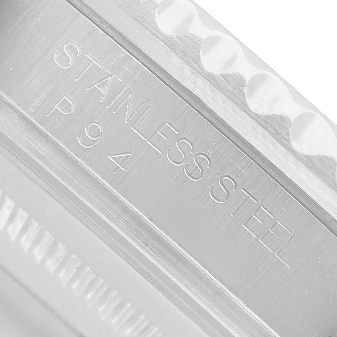 The image shows the side engraving on the stainless steel case of a Rolex GMT-Master 16710 Men's Stainless Steel Black Dial watch.