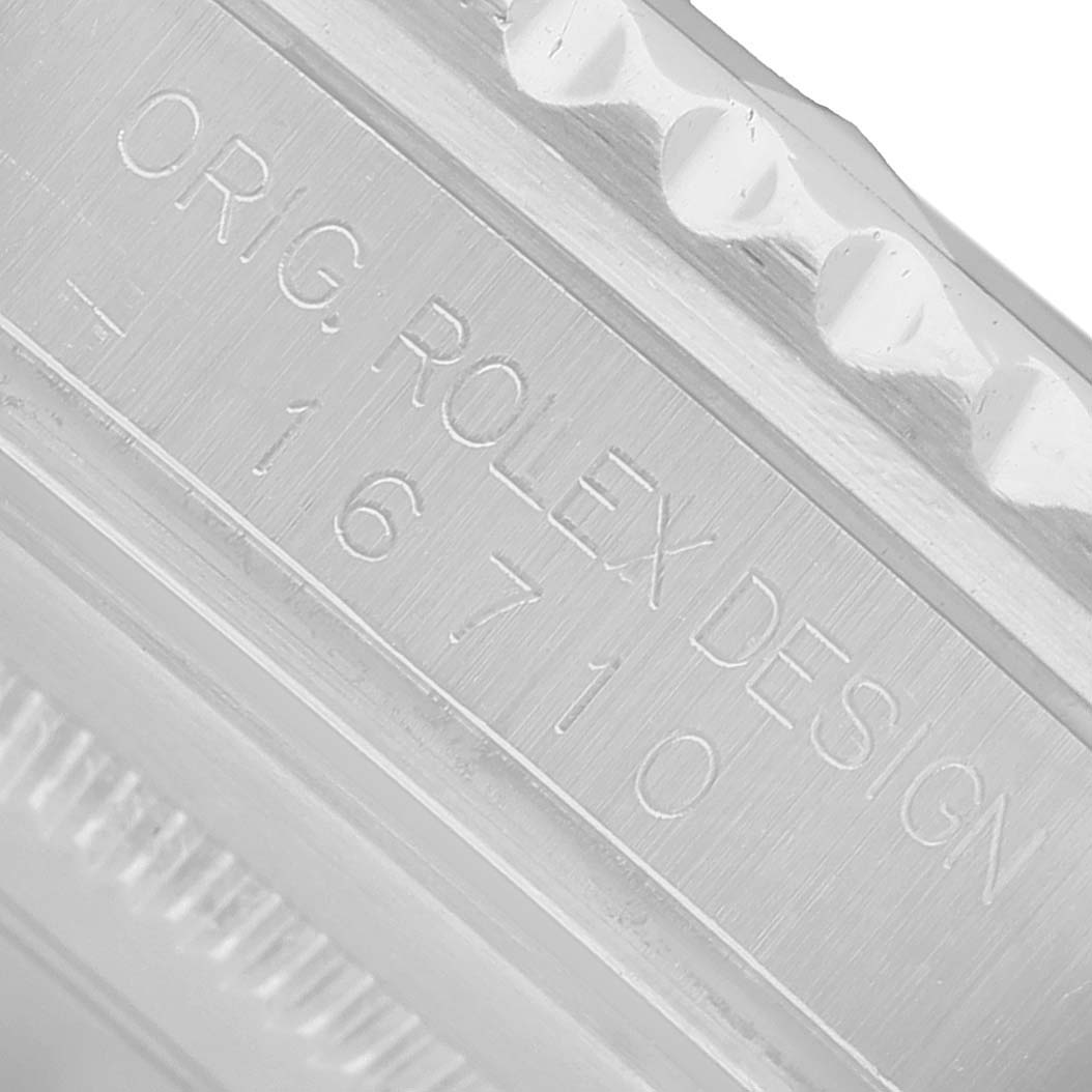 The image shows a close-up of the case with engraving details on the Rolex GMT-Master 16710 Men's Stainless Steel Black Dial model.
