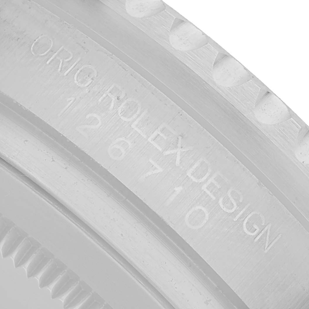 The image shows a close-up of the side of a Rolex GMT-Master 126710 Men's Stainless Steel Black Dial watch, highlighting engravings and bezel serration.