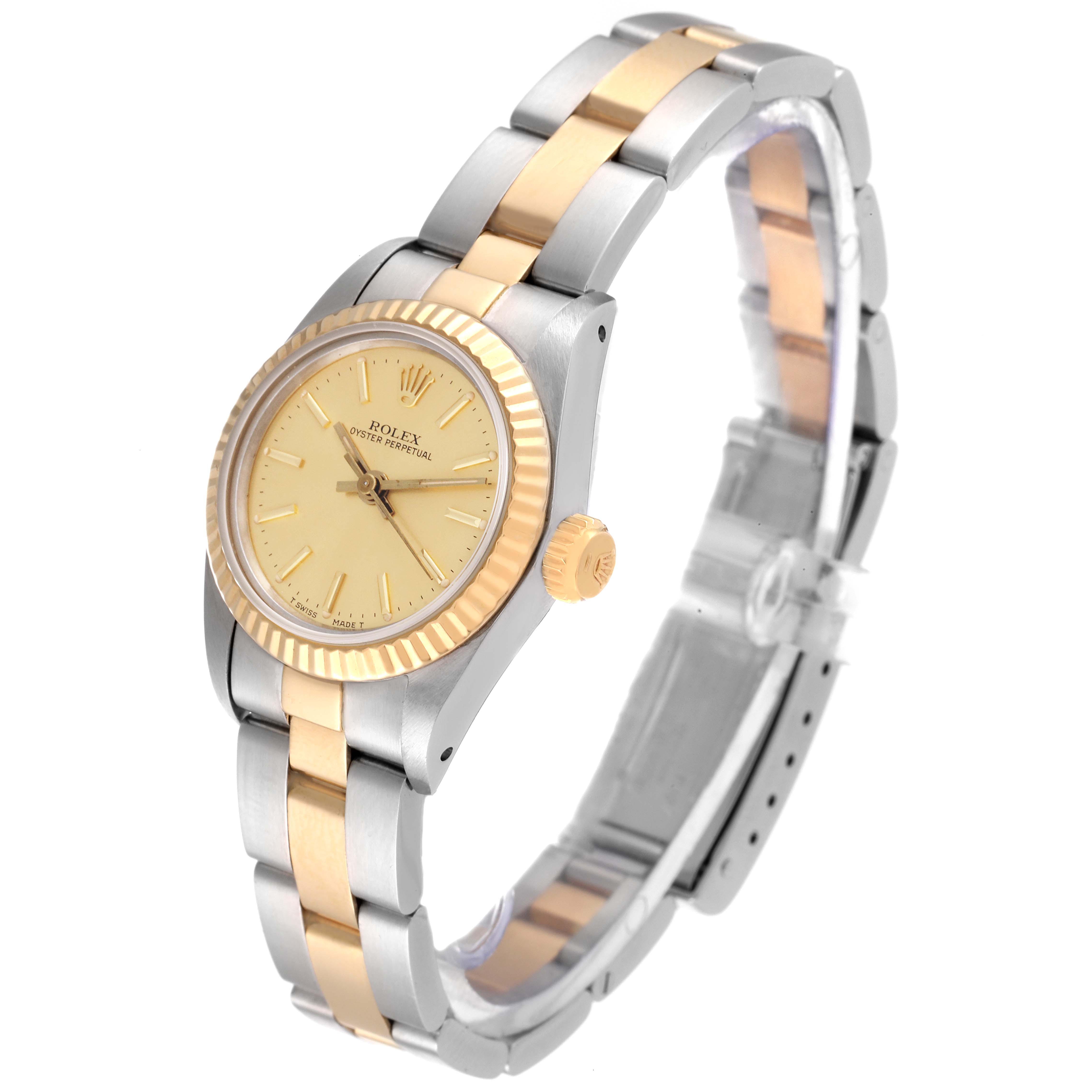 The Rolex Oyster Perpetual 67193 Women's Steel and Gold (two tone) Champagne Dial 67193 Women's Steel and Gold (two tone) Champagne Dial watch is shown at a 3/4 angle, highlighting its bezel, dial, and two-tone bracelet.