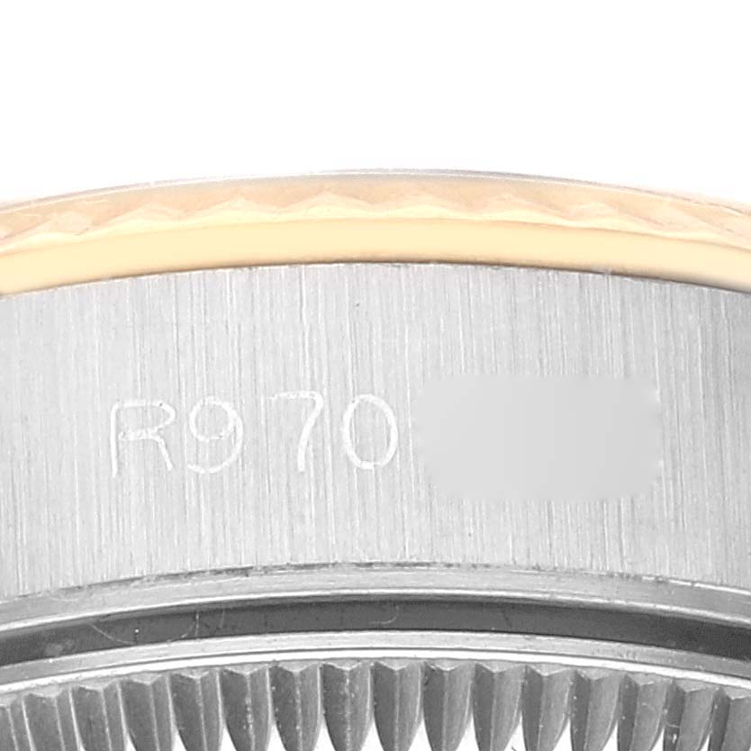 This image shows a close-up of the bezel with the model number (partially obscured) on a Rolex Oyster Perpetual 67193 Women's Steel and Gold (two tone) Champagne Dial 67193 Women's Steel and Gold (two tone) Champagne Dial watch.