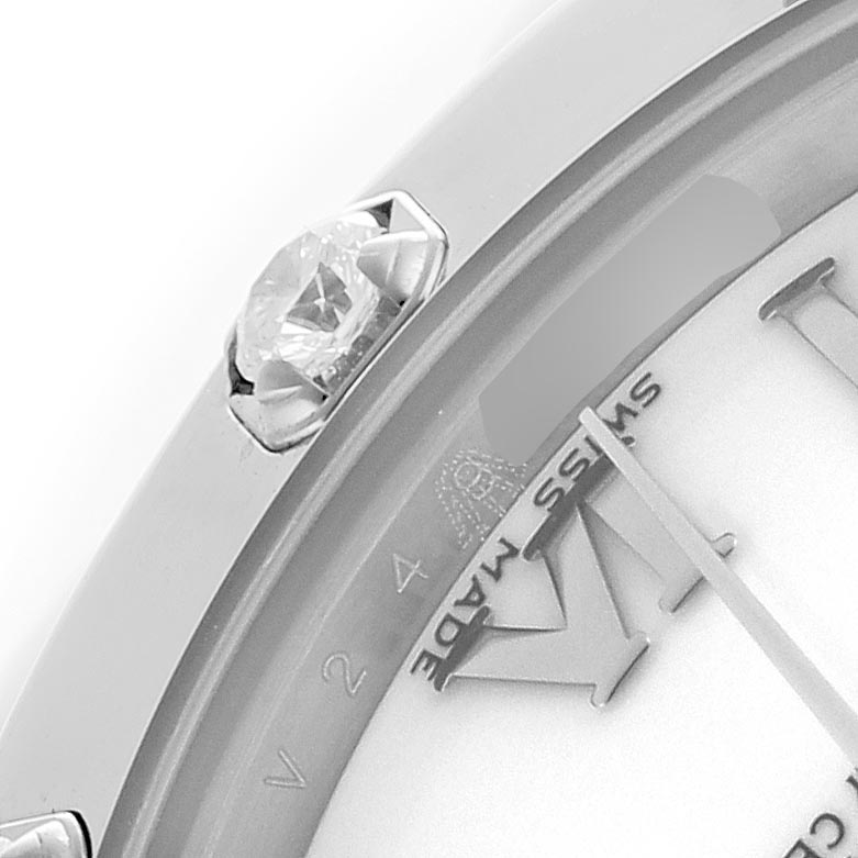 The image shows a close-up of the bezel and part of the dial of a Rolex Pearlmaster 81319 Women
s White Gold White Dial 81319 Women
s White Gold White Dial watch, highlighting a diamond and "Swiss Made" text.