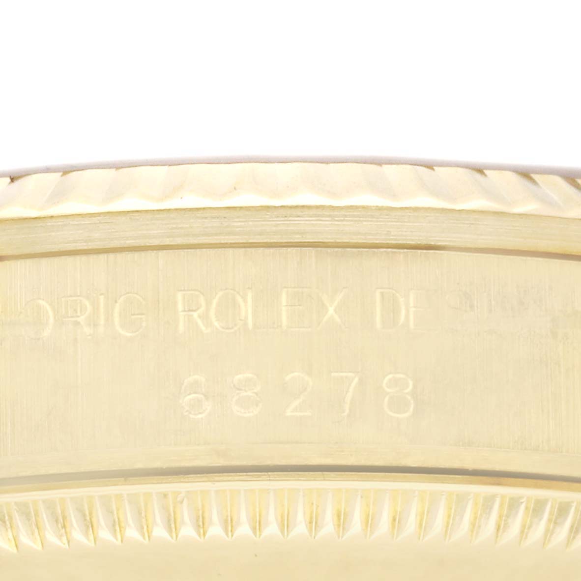 This image shows a close-up of the side case with engravings on a Rolex President 68278 Women's Yellow Gold Champagne Dial 68278 Women's Yellow Gold Champagne Dial model watch.
