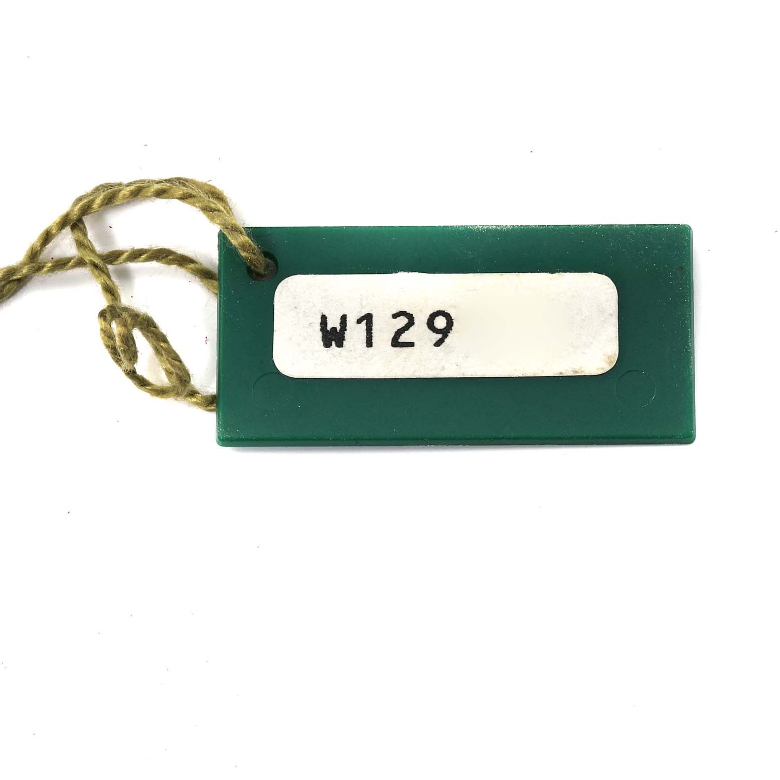 This image shows a green tag with a string, possibly an accessory or label for the Rolex President 68278 Women's Yellow Gold Champagne Dial 68278 Women's Yellow Gold Champagne Dial model watch.