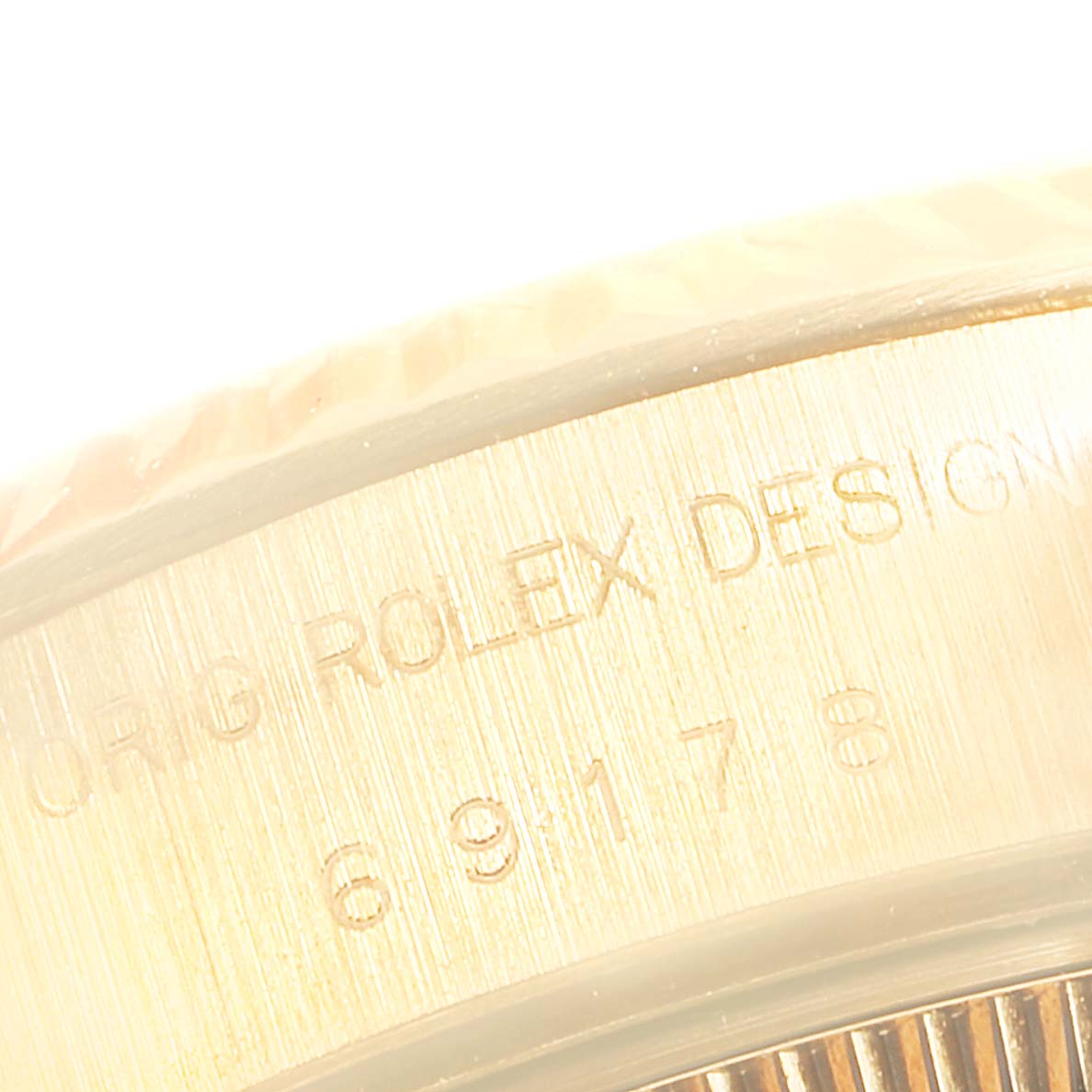 The image shows a close-up of the side of a Rolex President 69178 Women's Yellow Gold Mother of Pearl Dial 69178 Women's Yellow Gold Mother of Pearl Dial model watch, displaying the "ORIG ROLEX DESIGN" text and part of a serial number.