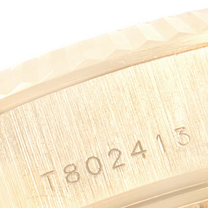 This image shows a close-up angle of the side of a Rolex President 69178 Women's Yellow Gold Mother of Pearl Dial 69178 Women's Yellow Gold Mother of Pearl Dial model watch, highlighting the serial number engraving.
