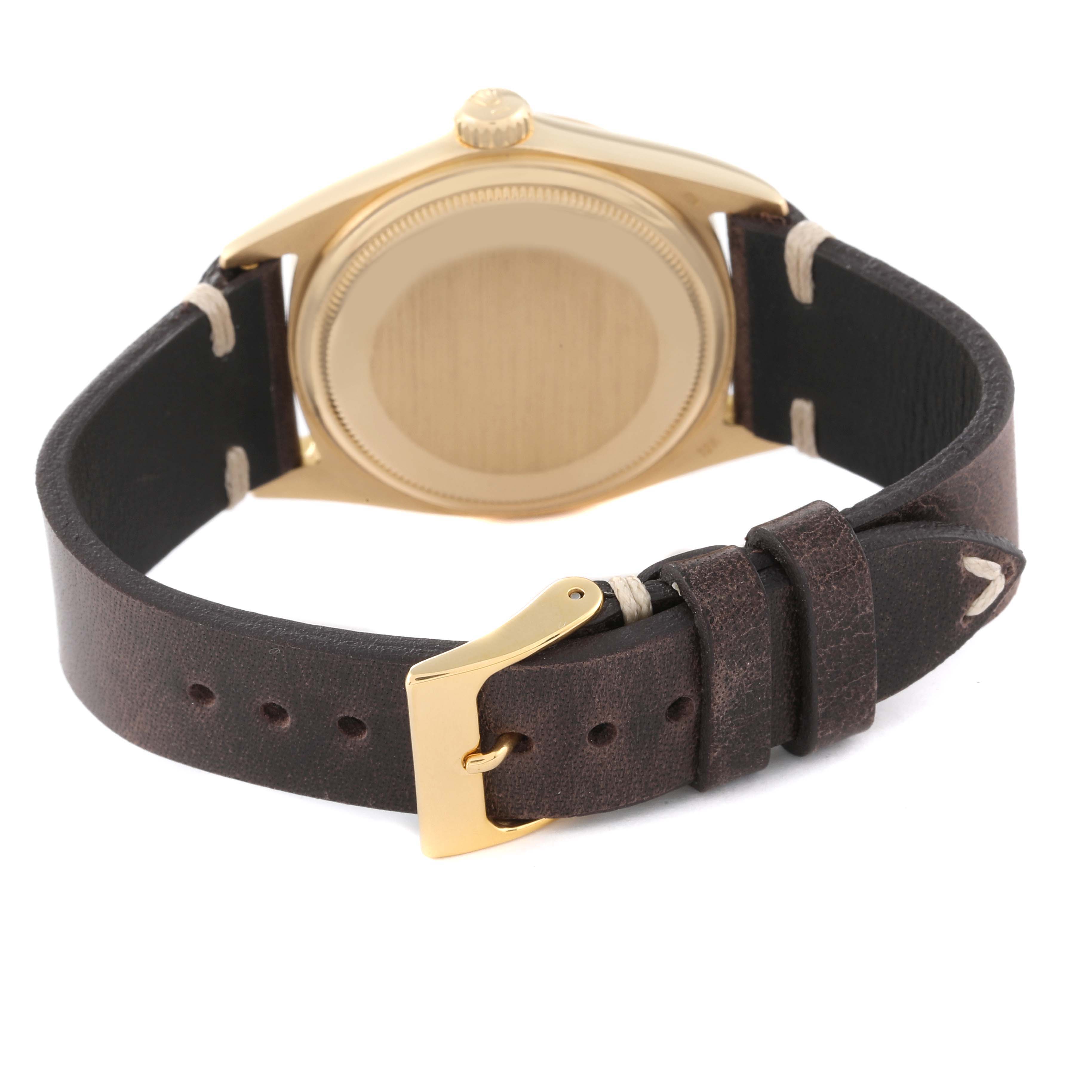 The image shows the back view of a Vintage Collection Rolex watch, highlighting its case, crown, and leather strap with buckle.