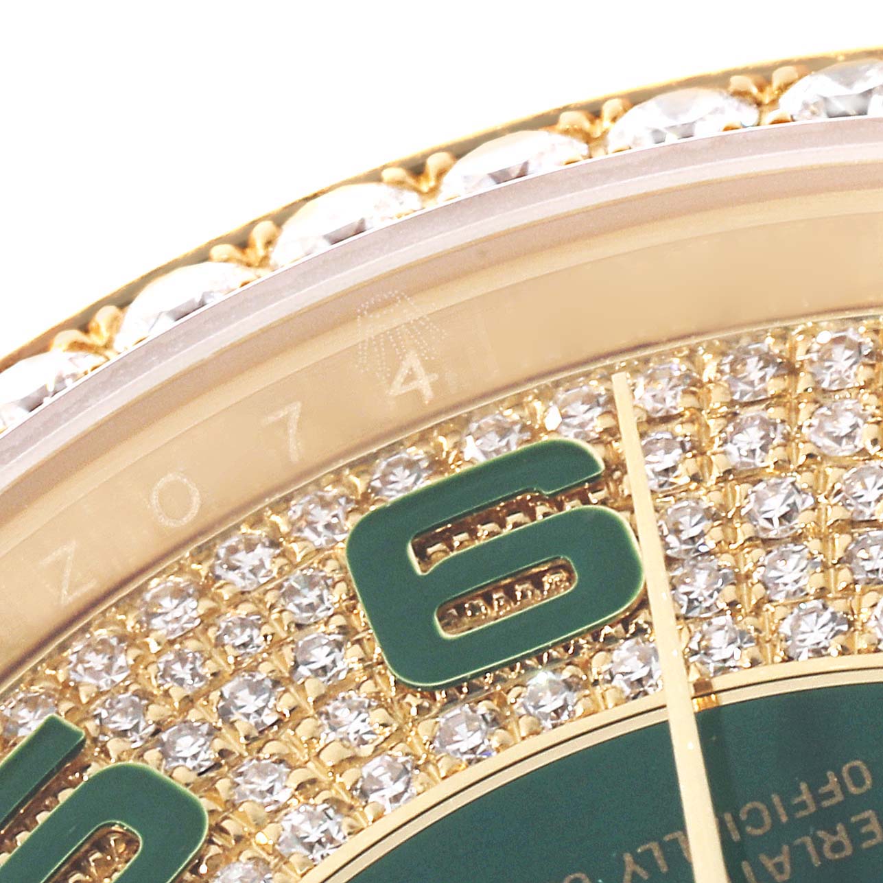 The image shows a close-up of the Rolex President 118348 Men's Yellow Gold Green Dial model's diamond-encrusted bezel and part of the dial with gold and green detailing.