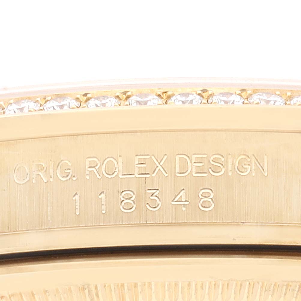 The image shows a close-up of the Rolex President 118348 Men's Yellow Gold Green Dial watch's engraved side, featuring the model number and diamond-adorned bezel.
