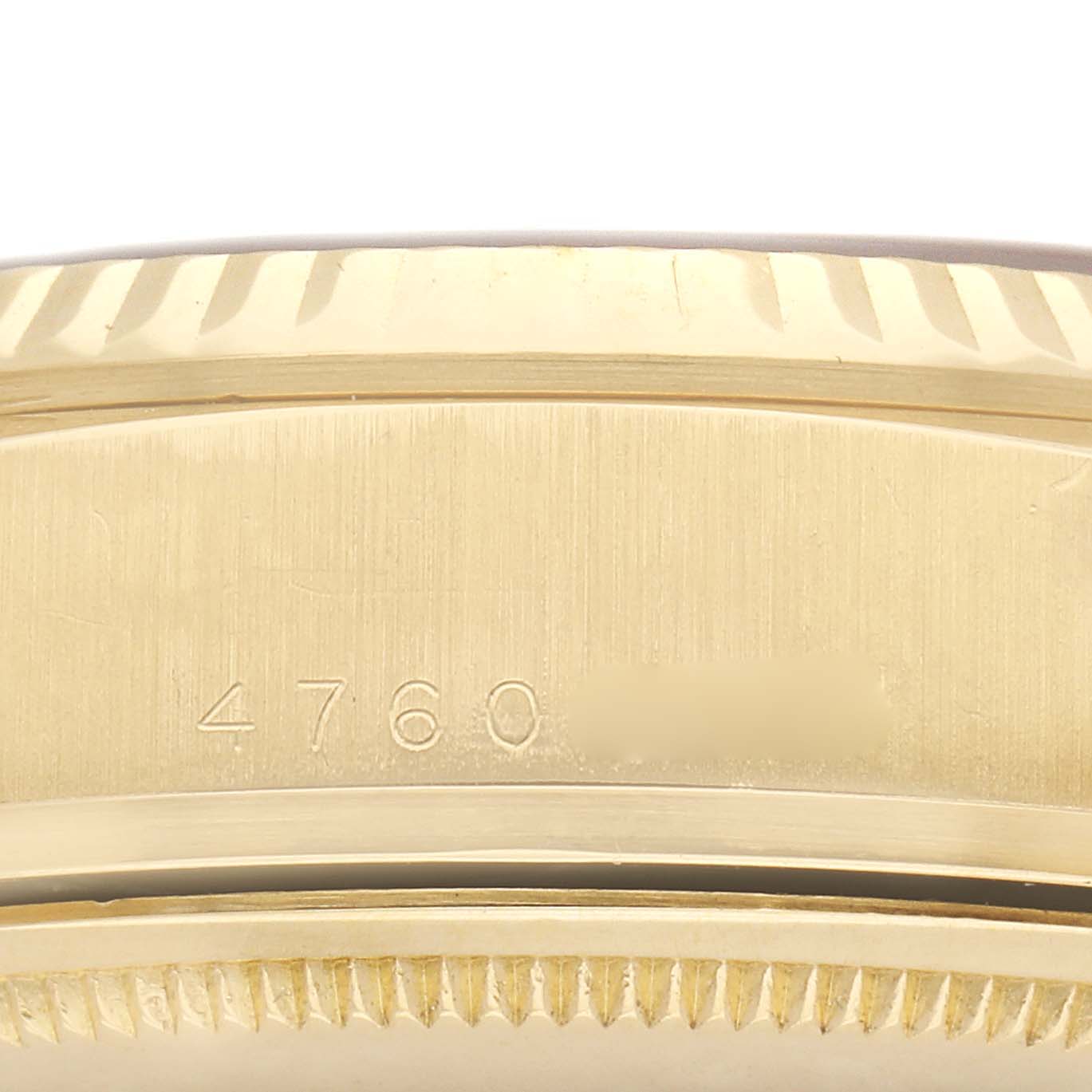 The image shows a close-up of the edge and bezel of the Rolex President 18038 Men's Yellow Gold Champagne Dial 18038 Men's Yellow Gold Champagne Dial model, featuring a serial number engraving.