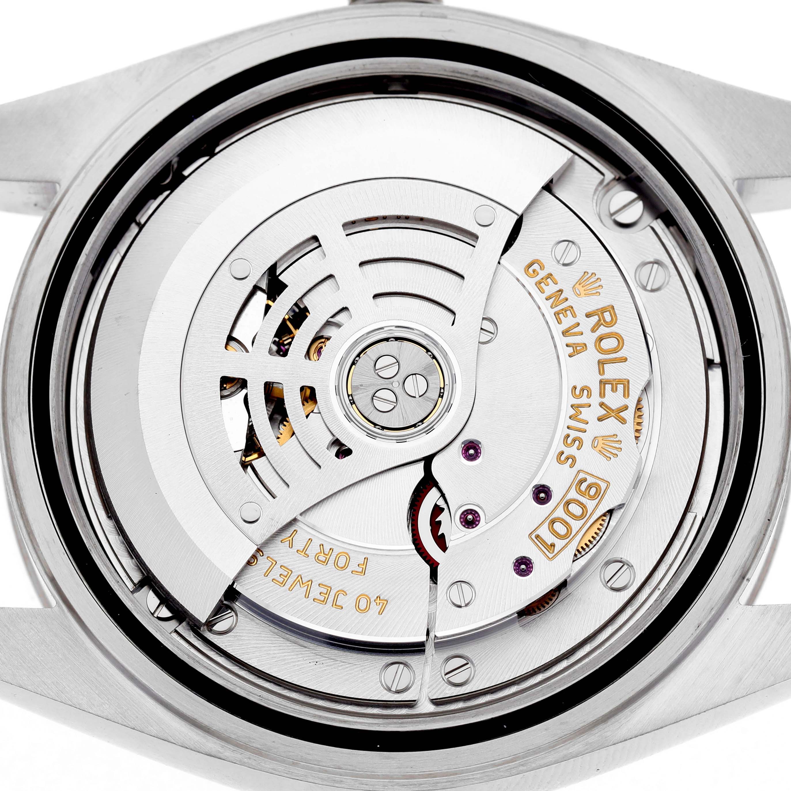 The image shows the movement of a Rolex Sky-Dweller 326934 Men's Stainless Steel Black Dial watch from a back view, highlighting the intricate mechanics and engravings.