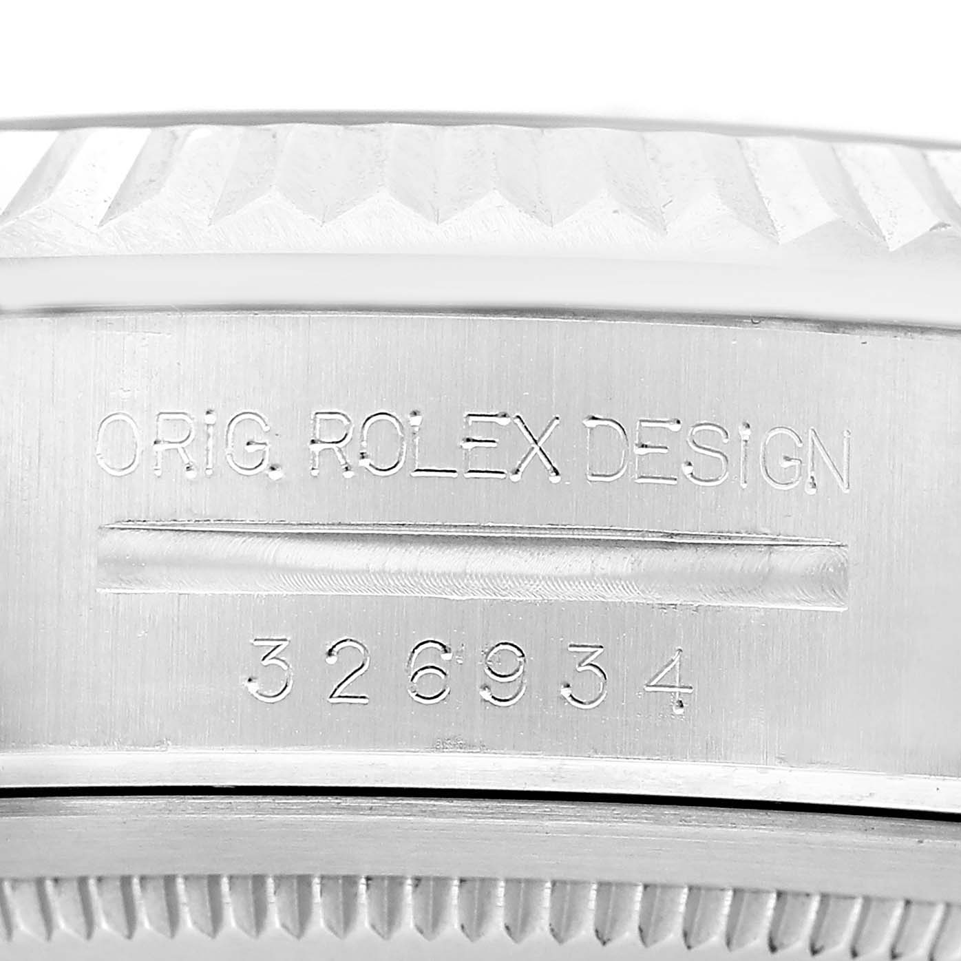 The image shows the side of a Rolex Sky-Dweller 326934 Men's Stainless Steel Black Dial, focusing on its engraved model and design details.