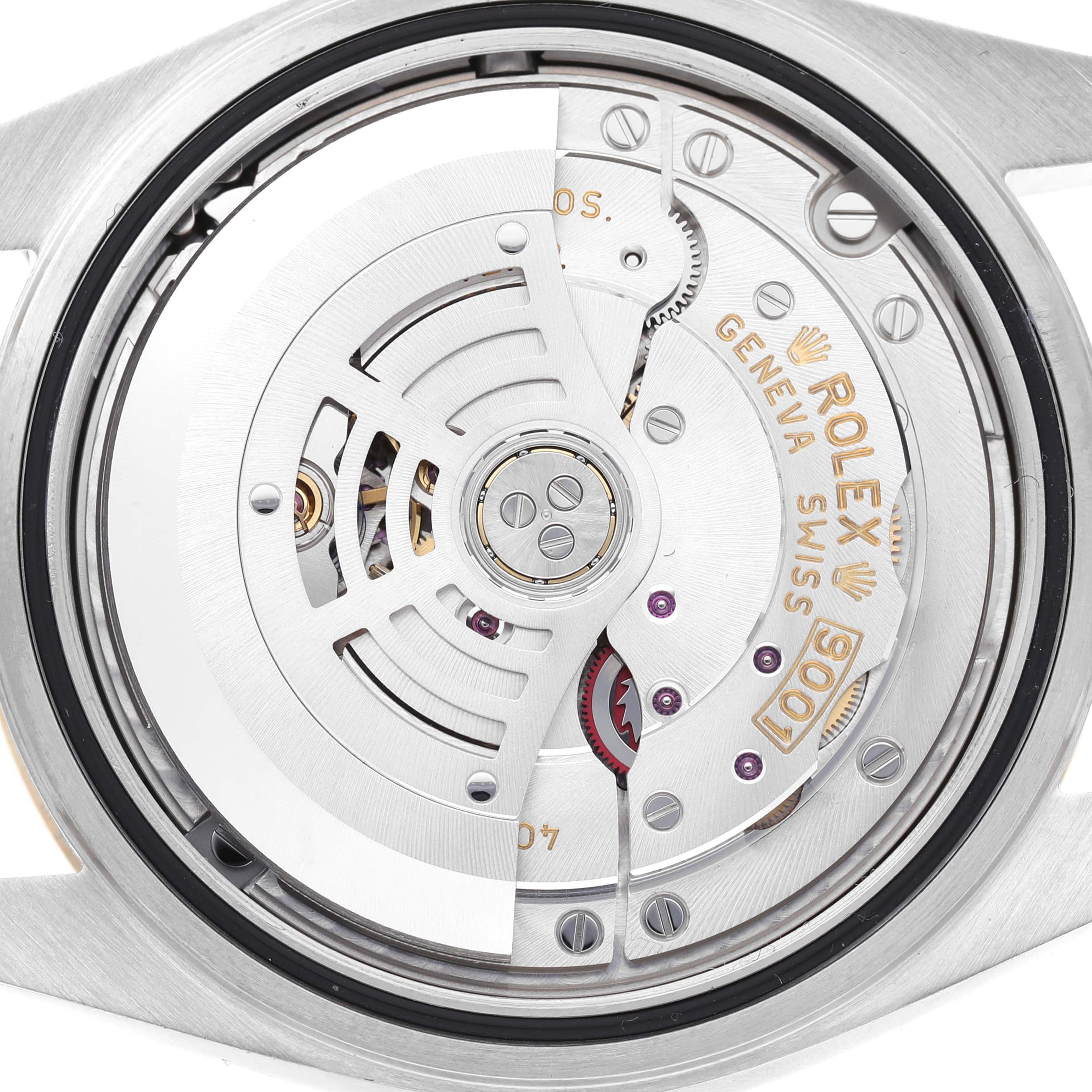 The image shows the movement of a Rolex Sky-Dweller 326933 Men's Steel and Gold (two tone) Black Dial watch from the back, highlighting intricate details and engravings.