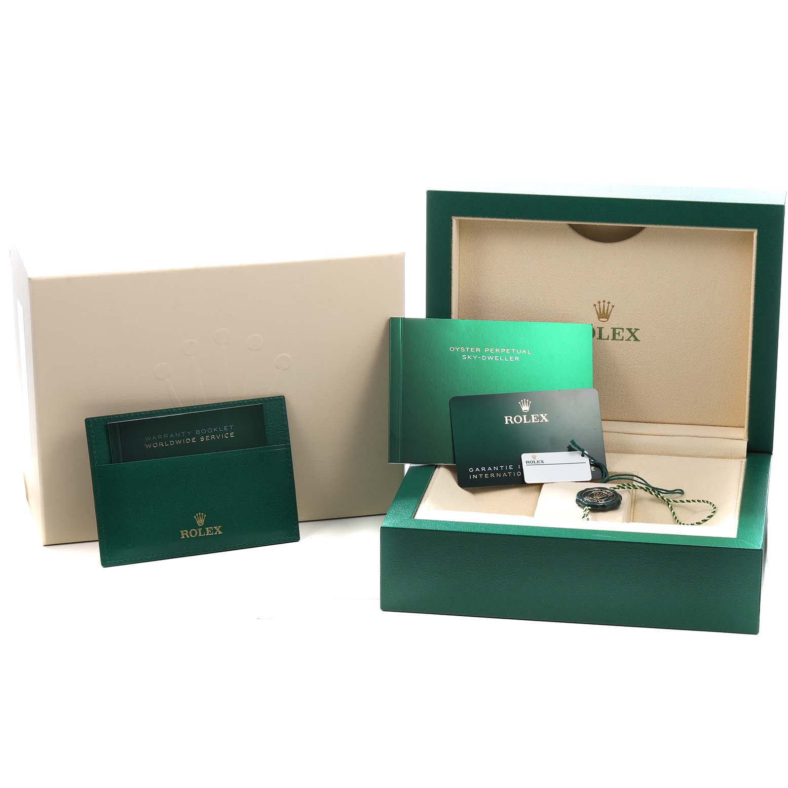 The image shows the packaging and accessories for a Rolex Sky-Dweller 326933 Men's Steel and Gold (two tone) Black Dial, including the box, warranty card, booklet, and tag.
