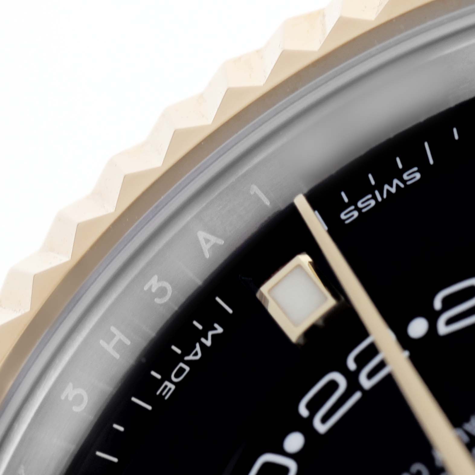 The image shows a close-up of the Rolex Sky-Dweller 326933 Men's Steel and Gold (two tone) Black Dial, highlighting the fluted bezel, part of the dial, and hour marker.