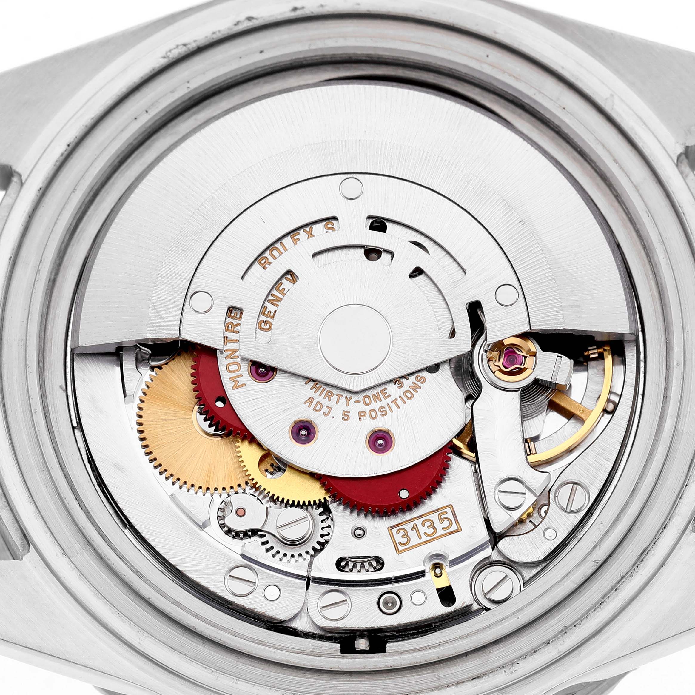 The image shows a close-up of the movement inside a Rolex Submariner 16610 Men's Stainless Steel Black Dial, highlighting gears and the rotor.