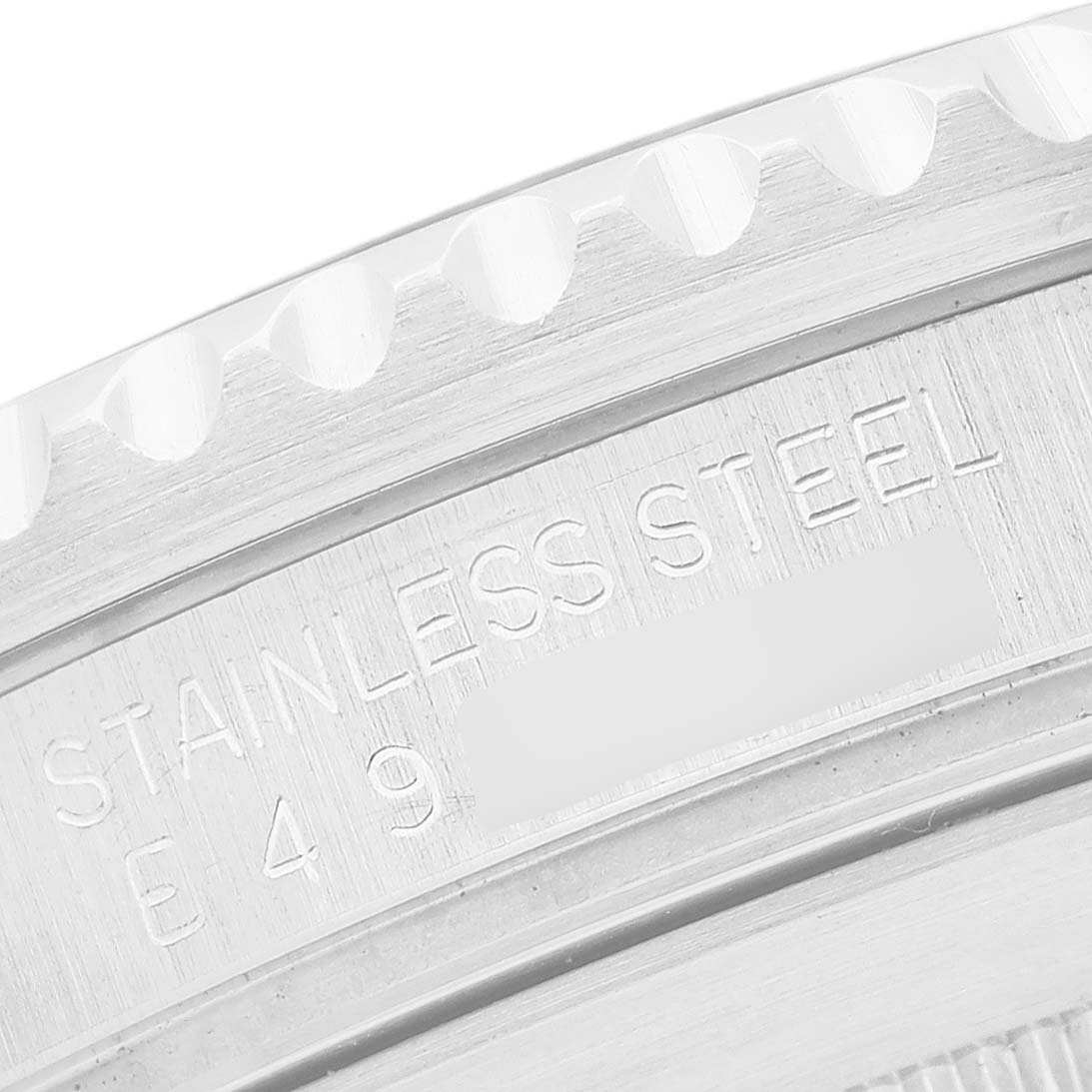 The image shows a close-up of the case back edge with engraving details of the Rolex Submariner 16610 Men's Stainless Steel Black Dial.