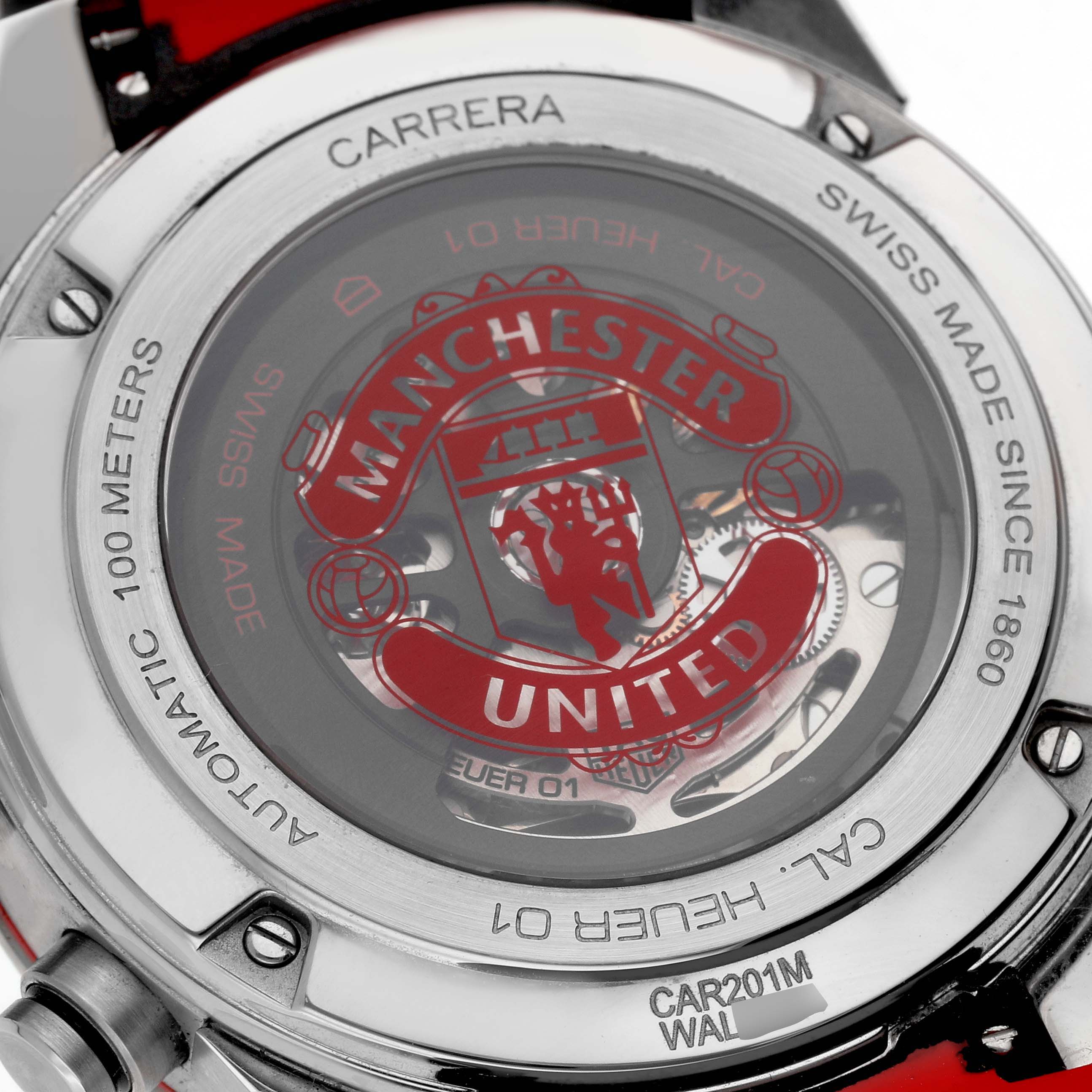 The image shows the back of the Tag Heuer Carrera CAR201M Men's Stainless Steel Silver Dial watch, highlighting the transparent case back and brand engravings.