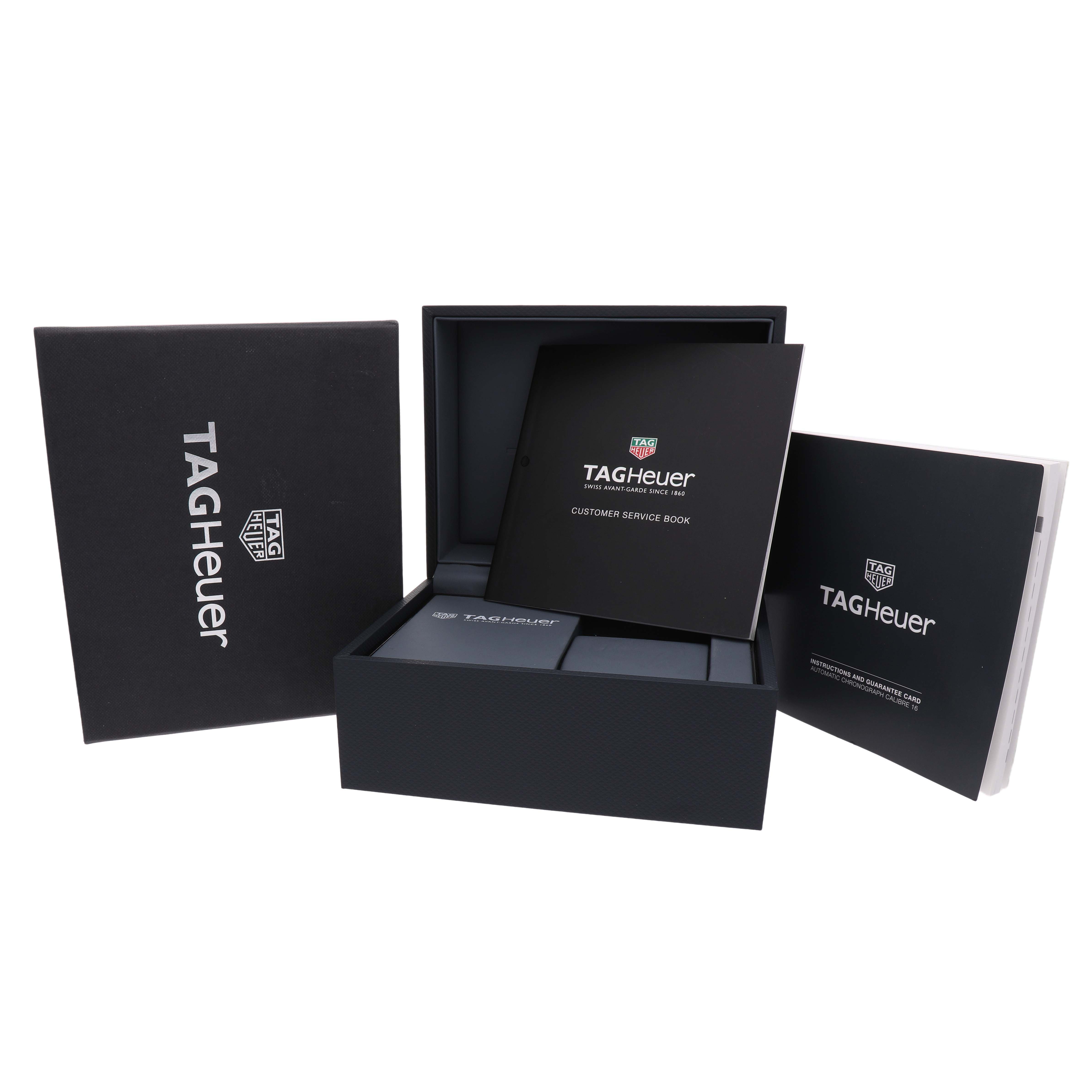 The image shows the Tag Heuer Carrera CAR201M Men's Stainless Steel Silver Dial watch's packaging with boxes and manuals at a slight top angle.