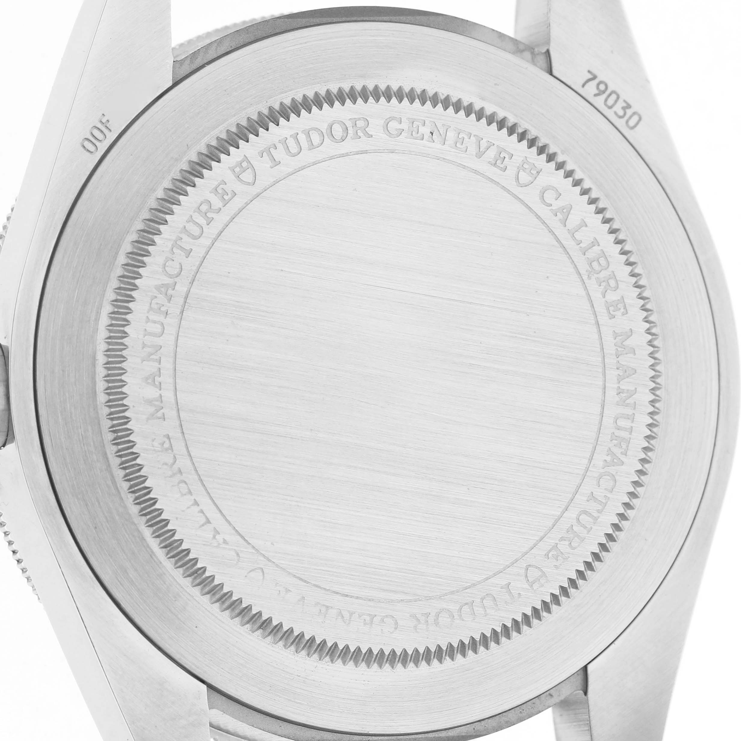 The image shows the case back of a Tudor Heritage Black Bay 79030 Men's Stainless Steel Black Dial watch, displaying engravings and serial numbers.