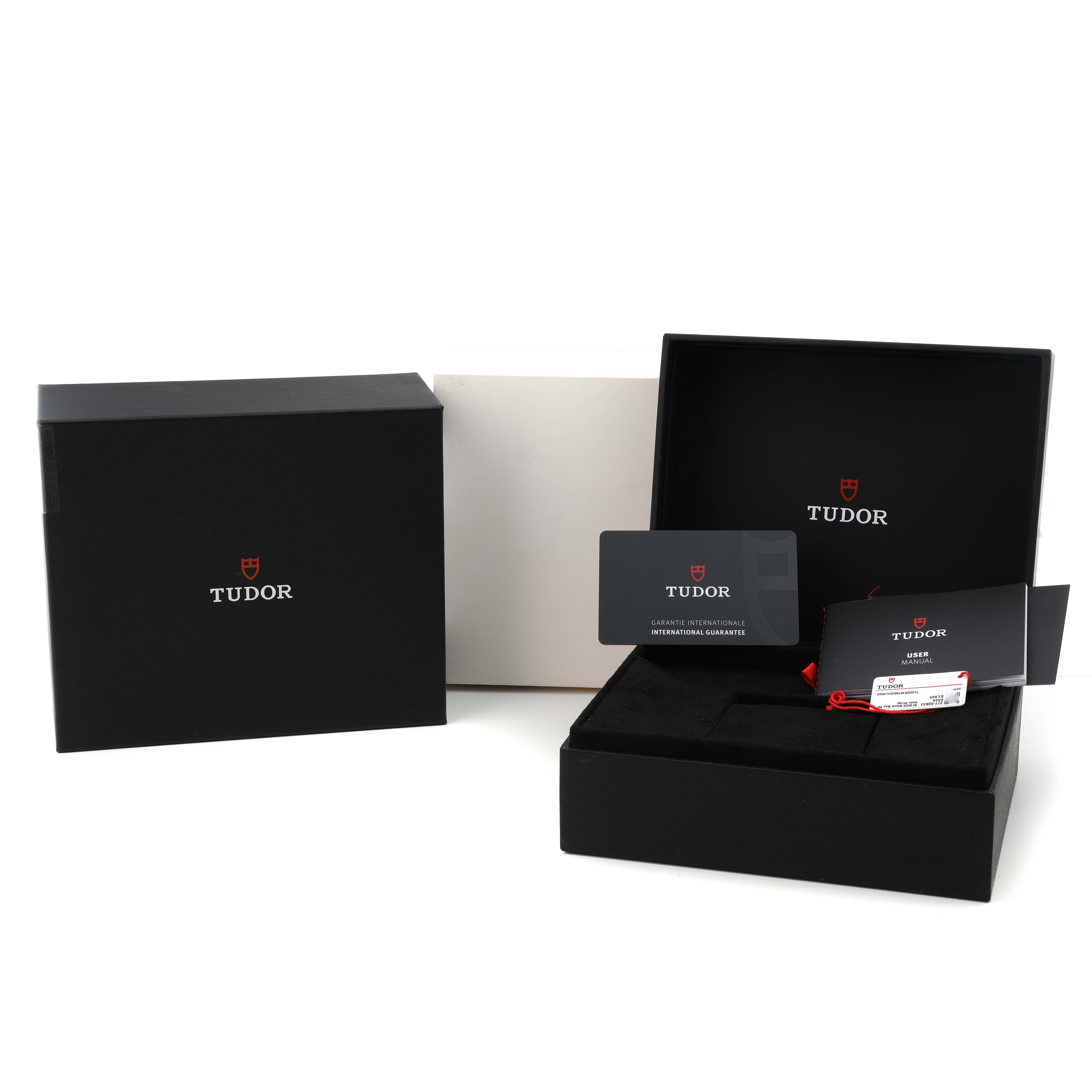 The image shows the packaging and accessories for the Tudor Heritage Black Bay 79030 Men's Stainless Steel Black Dial, including boxes and warranty cards.