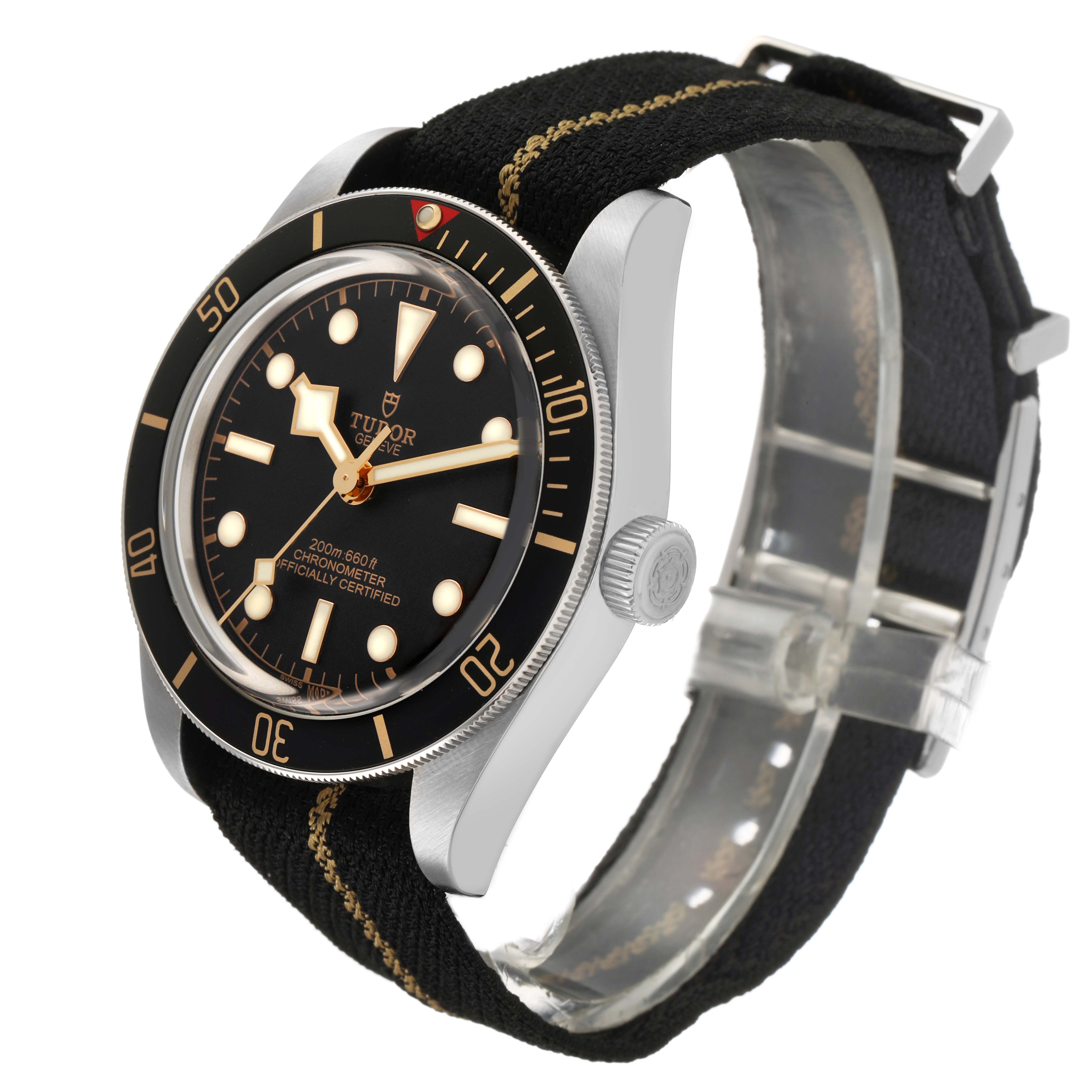 The Tudor Heritage Black Bay 79030 Men's Stainless Steel Black Dial watch is shown at a three-quarter angle with a clear view of the dial, bezel, crown, and strap.