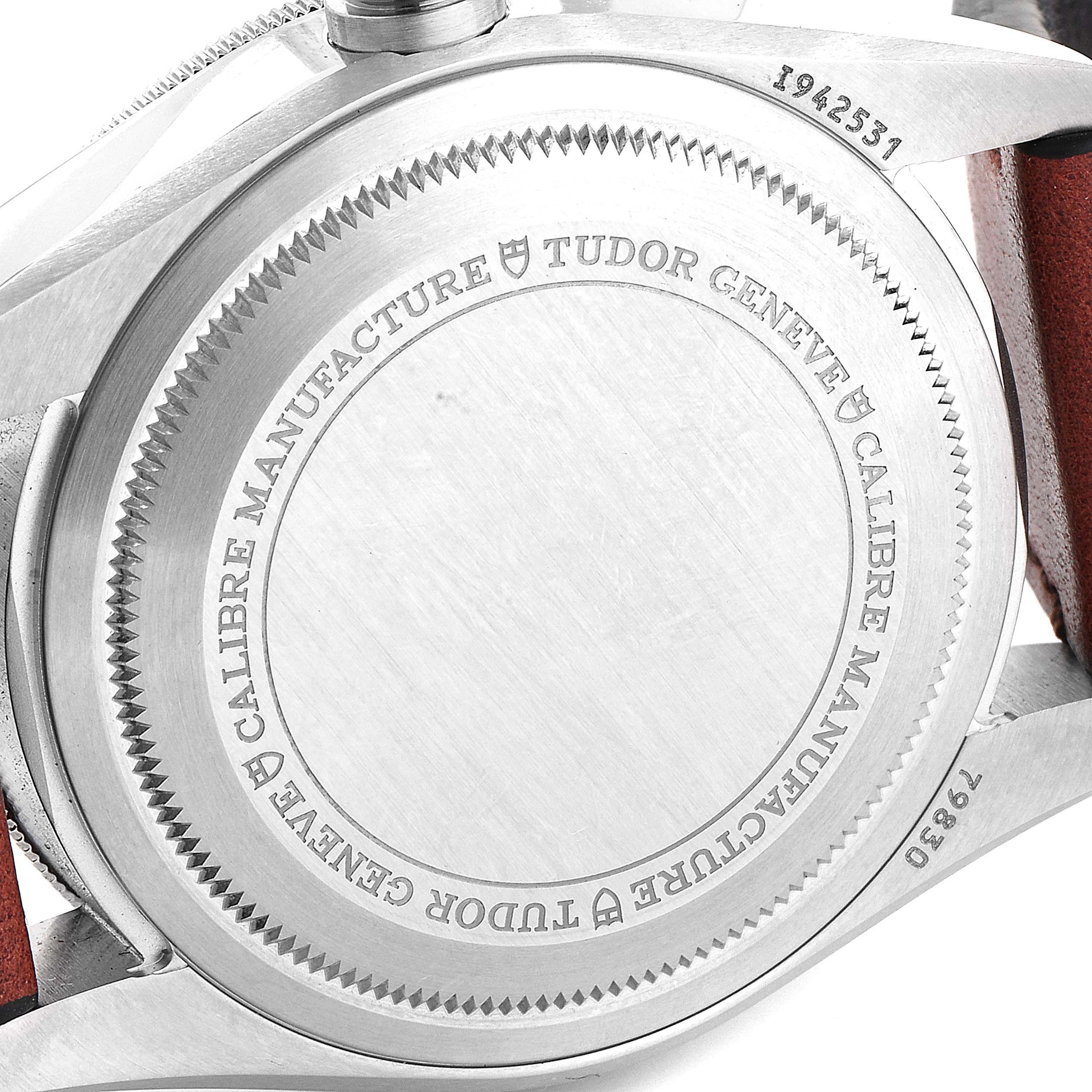 The image shows the back case of a Tudor Heritage Black Bay 79830RB Men
s Stainless Steel Black Dial 79830RB Men
s Stainless Steel Black Dial watch, highlighting the engraved details.