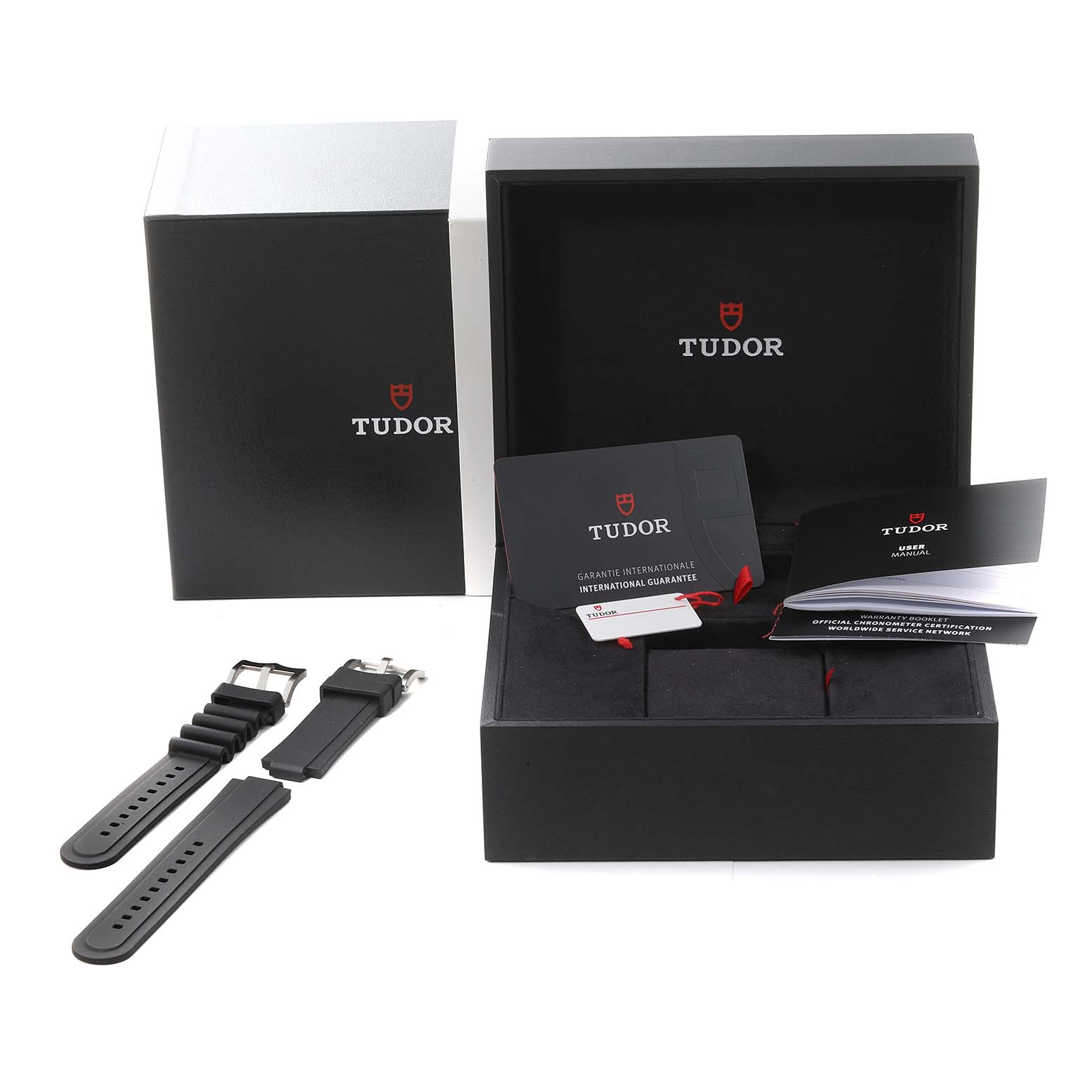 The image shows the Tudor Pelagos M25600TN-0001 Men
s Titanium Black Dial M25600TN-0001 Men
s Titanium Black Dial packaging with an open box, extra straps, and warranty documents.