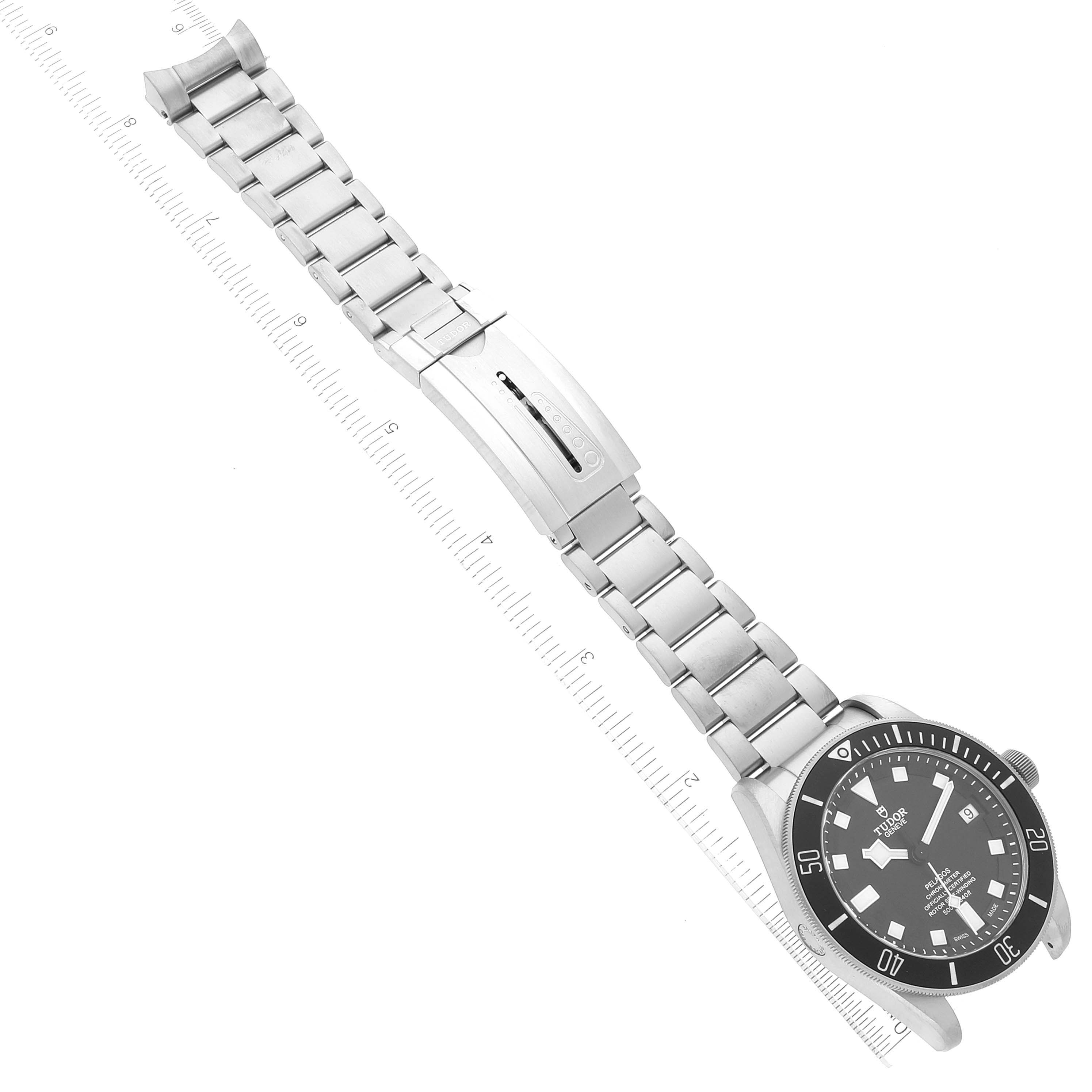 The image shows the Tudor Pelagos M25600TN-0001 Men
s Titanium Black Dial M25600TN-0001 Men
s Titanium Black Dial watch from a top-down angle, highlighting its metal bracelet and clasp.