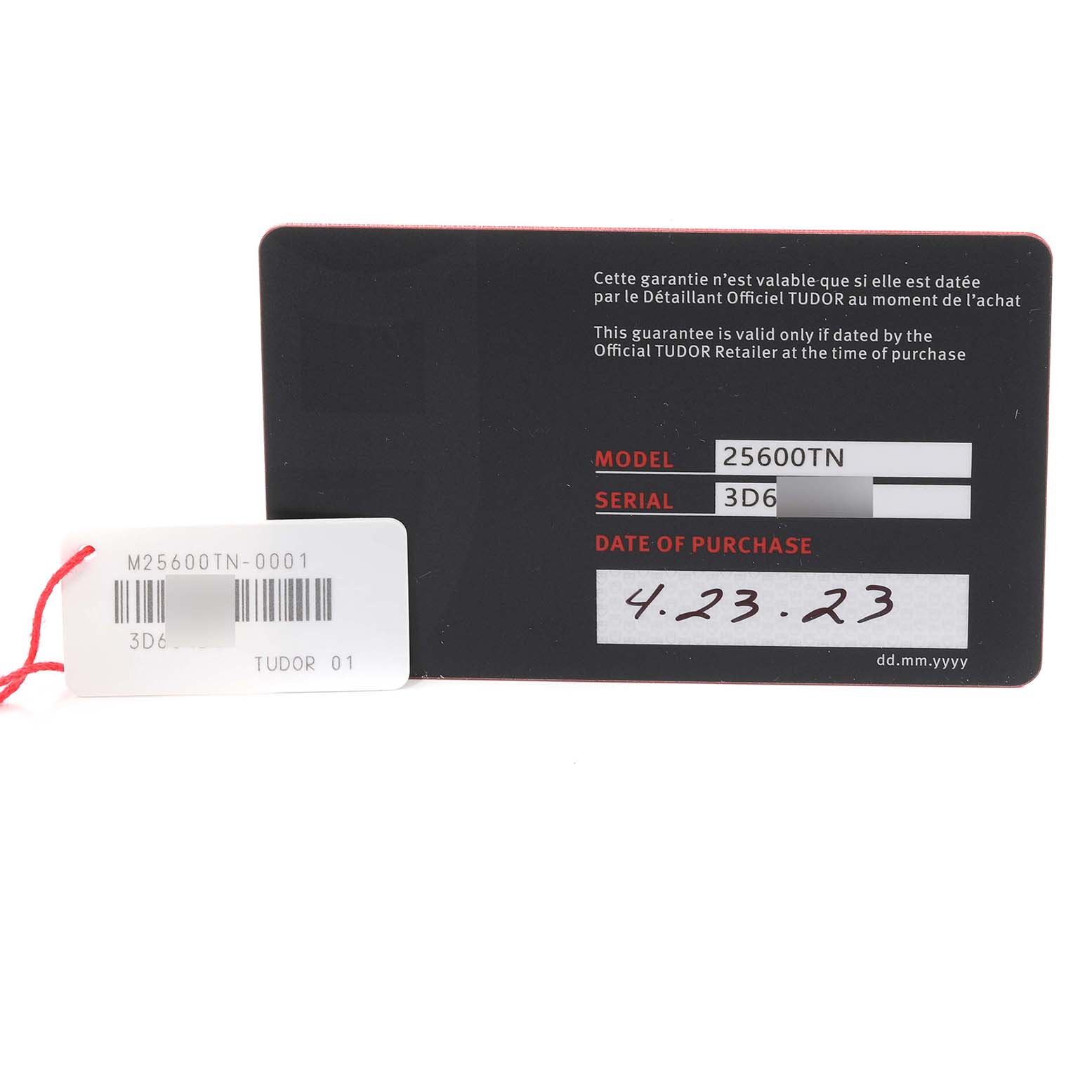 The image shows the warranty card and tag for the Tudor Pelagos M25600TN-0001 Men
s Titanium Black Dial M25600TN-0001 Men
s Titanium Black Dial model 25600TN with purchase date 4.23.23.